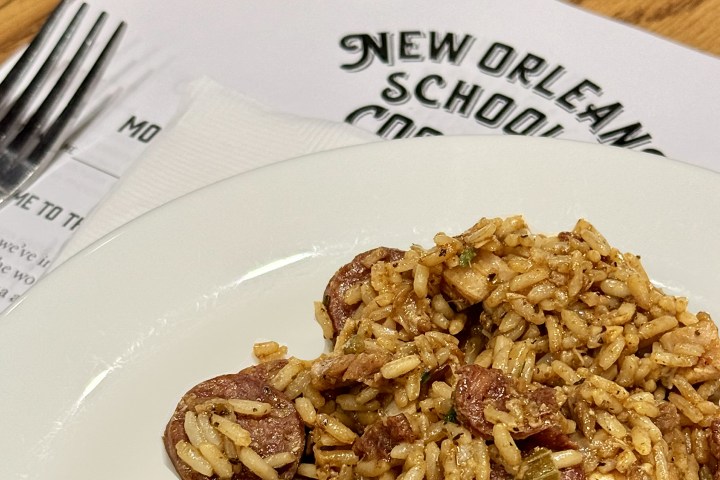 Plate of rice and sausage with New Orleans text in the background.