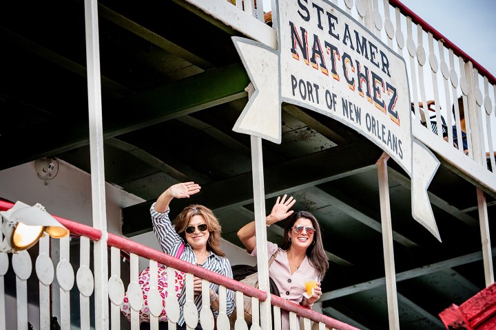 Two women wave from the deck of the Steamer Natchez in New Orleans.
