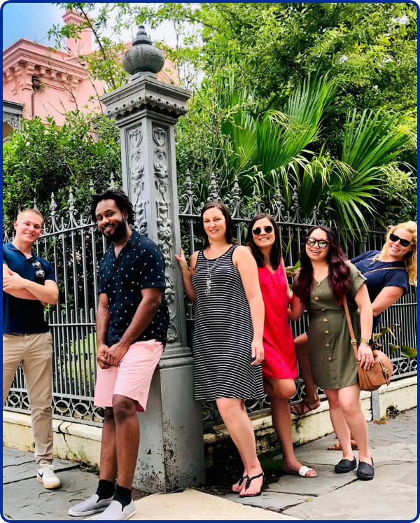 a group of people standing in front of a crowd posing for the camera