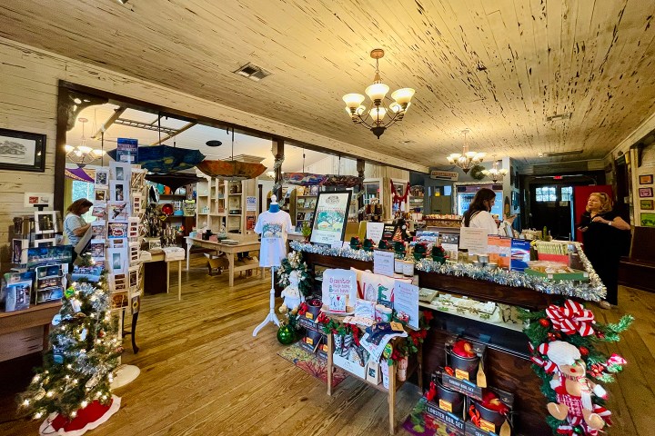Interior of a gift shop with holiday decorations and various items on display.